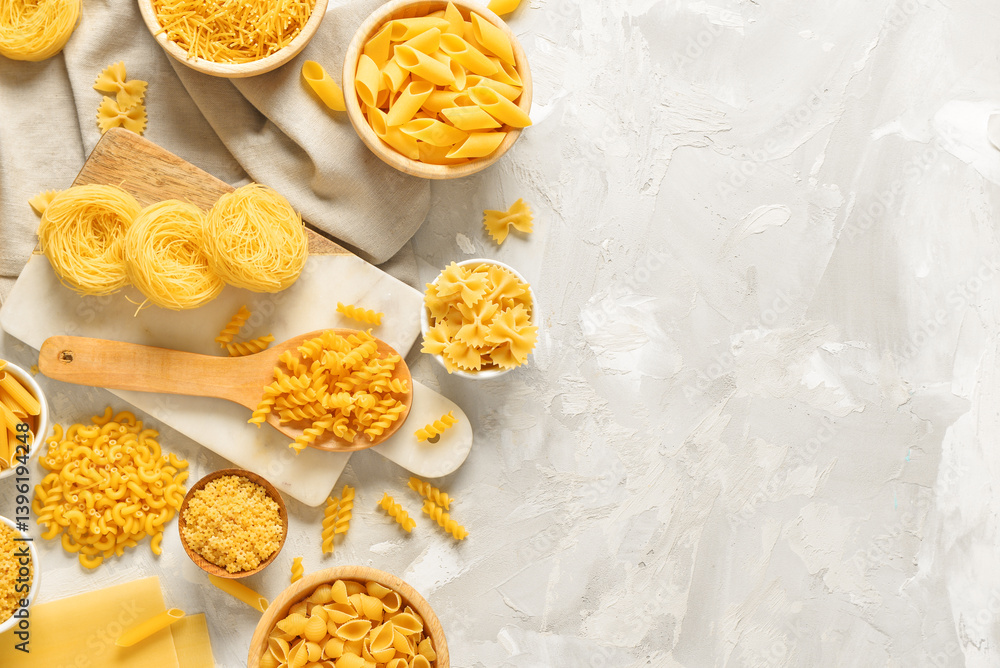Composition with different raw tasty pasta on light background