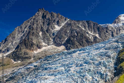 Aiguille du Midi peak in the Alps. Chamonix valley landscape of a prominent rocky towering mountain peak in French Alps. Chamonix-Montblanc area beautiful landscape of Aiguille du Midi summit, France