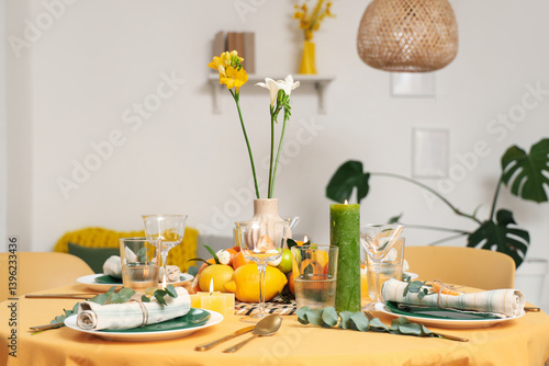Wallpaper Mural Beautiful table setting with citrus fruits, flowers and burning candles in room. Closeup Torontodigital.ca