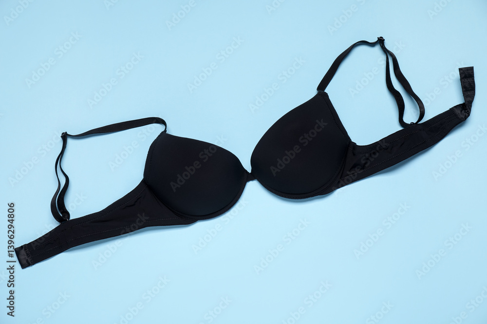 Beautiful black bra on light blue background, top view Beautiful black bra on light blue background, top view