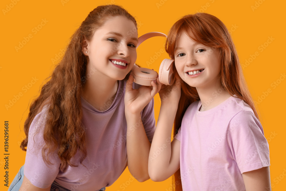 Beautiful young woman with her cute daughter holding modern headphones on yellow background. Mother's Day celebration Beautiful young woman with her cute daughter holding modern headphones on yellow background. Mother's Day celebration