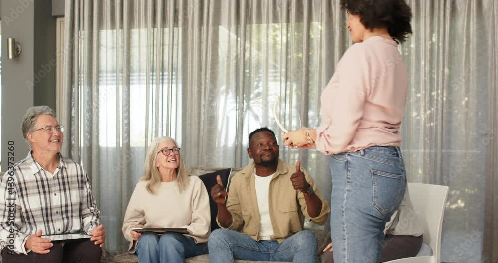 Happy female therapist handing certificate to patient, with diverse patients in group therapy Happy female therapist handing certificate to patient, with diverse patients in group therapy