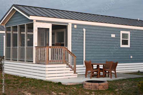 Blue single generic Modern camping cabin tiny home in a line on beach with screed in porch