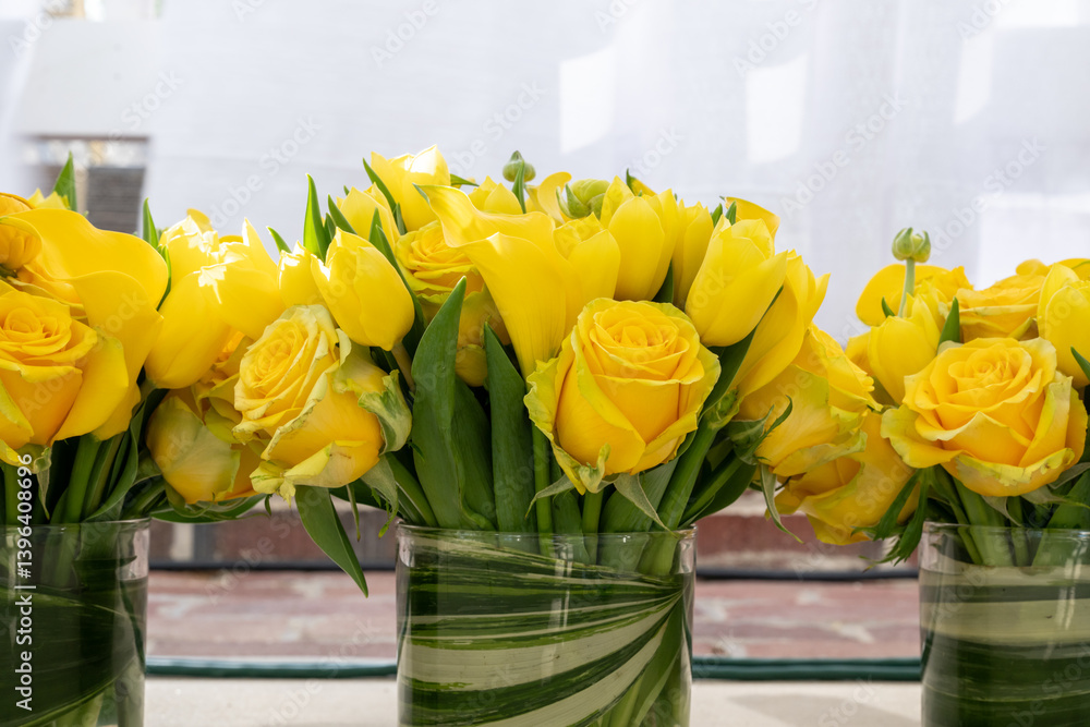 Bouquets of Yellow Roses in Glass Jars