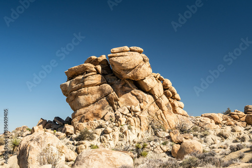 Classic Smooth Rocks Of Joshua Tree Against Bright Blue Sky