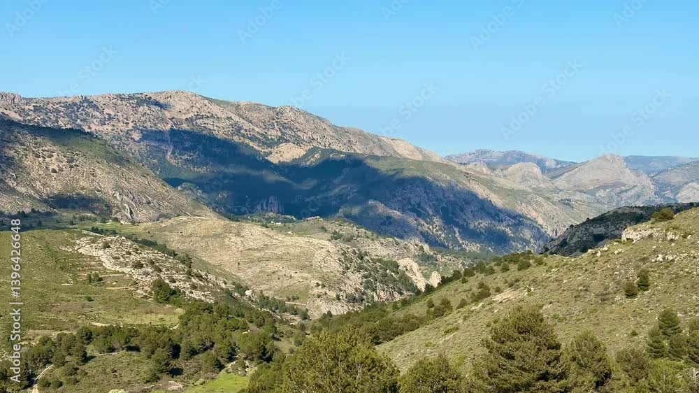 Breathtaking views showcase rolling hills and majestic mountains set against a vibrant blue and expansive sky Breathtaking views showcase rolling hills and majestic mountains set against a vibrant blue and expansive sky