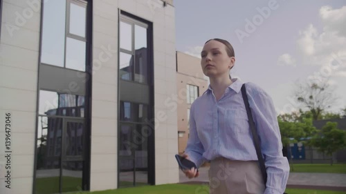 Wallpaper Mural Businesswoman Checking Urgent Message While Walking Near Modern Office Building Torontodigital.ca