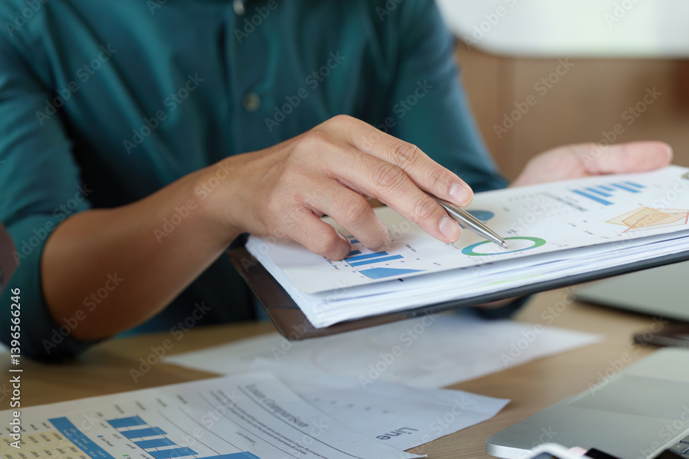 Data Analysis and Business Strategy. A business professional reviewing financial reports for strategic insights. Data Analysis and Business Strategy. A business professional reviewing financial reports for strategic insights.
