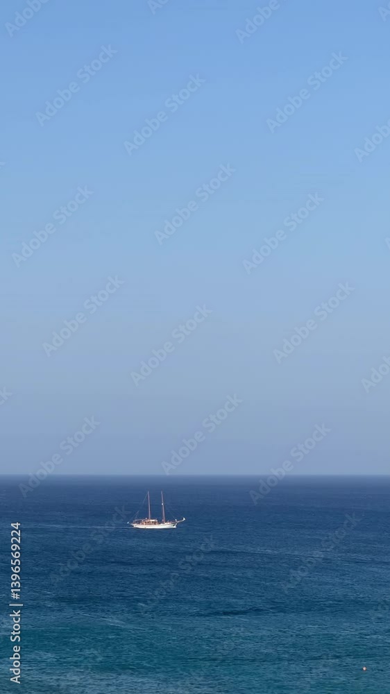 Enjoy a beautiful and serene ocean view that features a majestic sailing ship set on the horizon Enjoy a beautiful and serene ocean view that features a majestic sailing ship set on the horizon