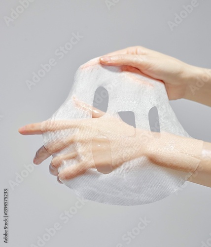 Moist hands that are spreading their mask packs
