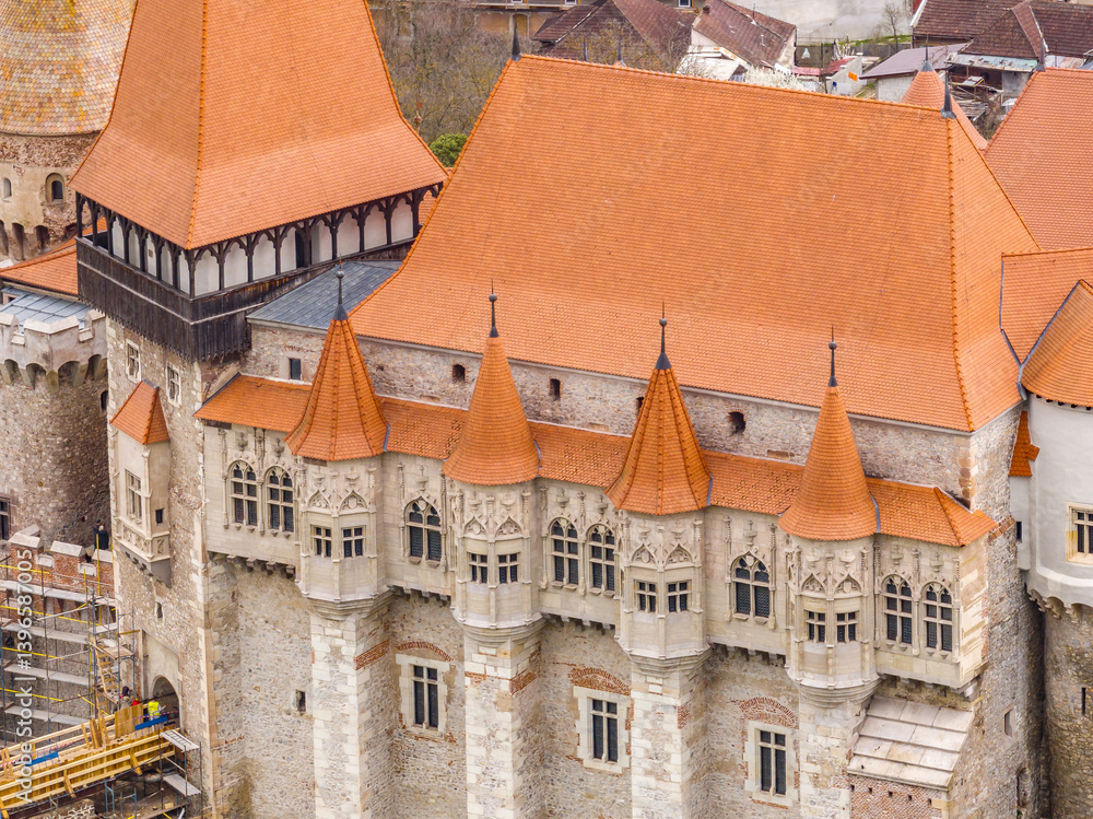 Aerial close up view of Corvin castle in Hunedoara Romania restored Gothic palace with red rood