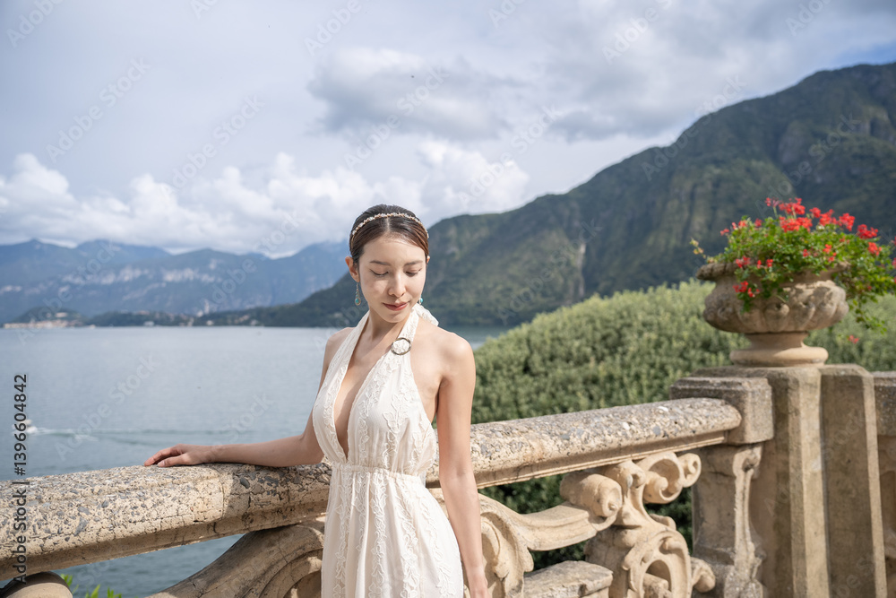 Woman standing on the old terrace balcony at Villa Balbianello. Lake Como, Italy. Woman standing on the old terrace balcony at Villa Balbianello. Lake Como, Italy.