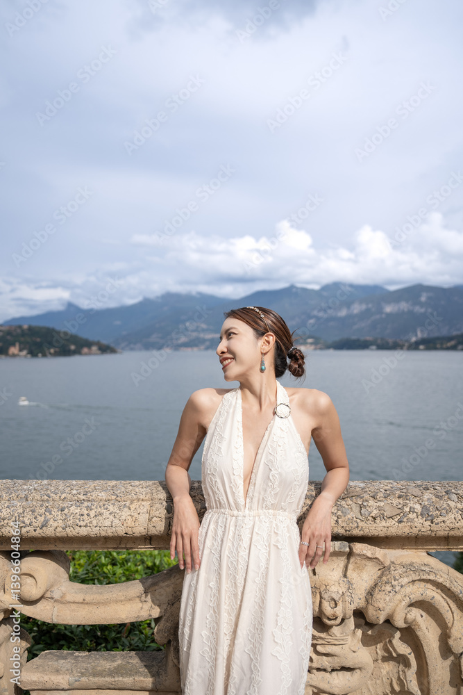 Woman standing on the old terrace balcony at Villa Balbianello. Lake Como, Italy. Woman standing on the old terrace balcony at Villa Balbianello. Lake Como, Italy.