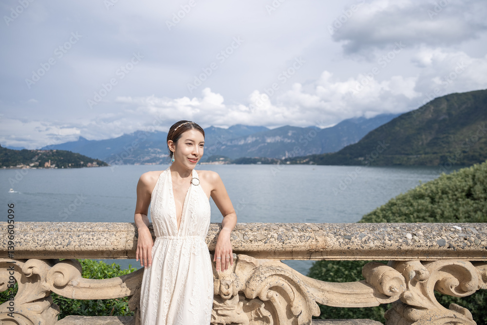 Woman standing on the old terrace balcony at Villa Balbianello. Lake Como, Italy. Woman standing on the old terrace balcony at Villa Balbianello. Lake Como, Italy.