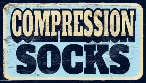 Aged vintage compression socks sign on wood