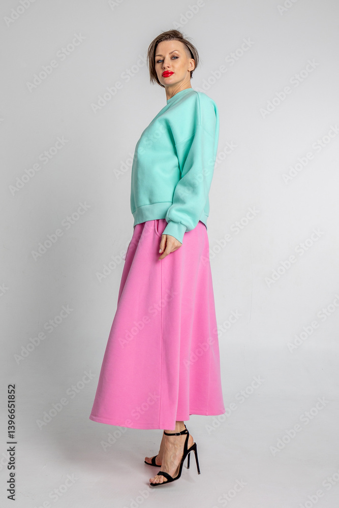 Beautiful girl of model appearance. Portrait of beautiful woman in mint color sweatshirt and pink skirt. Vertical photo. High quality photo Beautiful girl of model appearance. Portrait of beautiful woman in mint color sweatshirt and pink skirt. Vertical photo. High quality photo