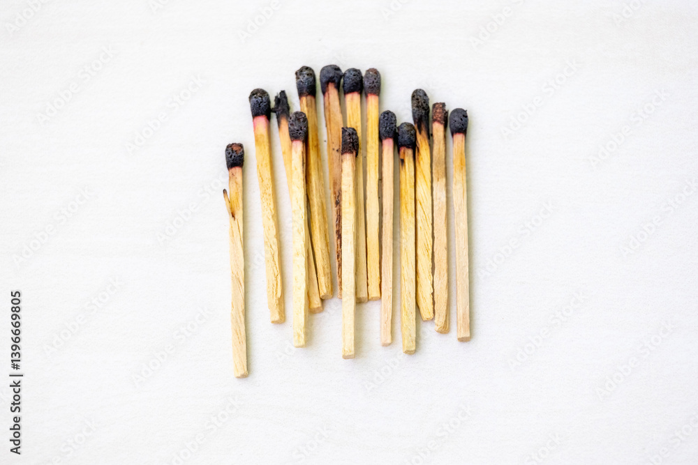 Burnt match sticks isolated on a white background. Many burnt wooden matchsticks in a row. Burnt match sticks isolated on a white background. Many burnt wooden matchsticks in a row.