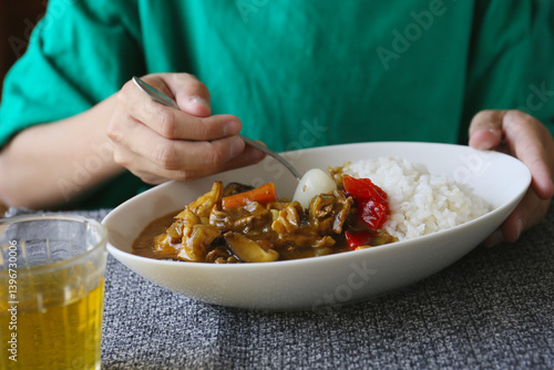 eating of japanese style curry rice, a child hand, no face