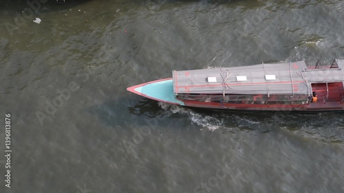 Aerial view of a passenger boat sailing on the Saen Saep Canal to pick up and drop off passengers at piers in Bangkok.Traveling by ferry is another option that can avoid traffic congestion on the road