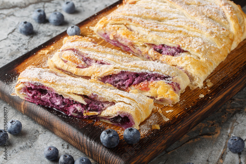 Obraz na płótnie Delicious blueberry pie with fresh berries and patissiere cream close-up on a wooden board on the table. Horizontal w salonie