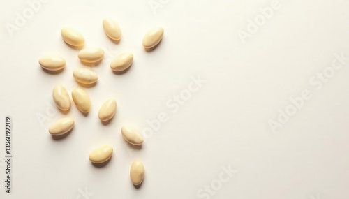 Scattered white beans on pristine white background, organic, vegetarian