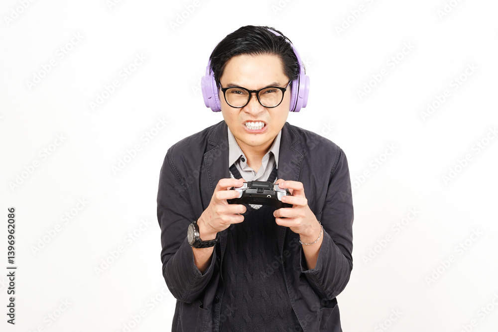 Wearing headphone and holding gamepad playing game while angry gesture Of Handsome Asian Man Isolated On White Background Wearing headphone and holding gamepad playing game while angry gesture Of Handsome Asian Man Isolated On White Background