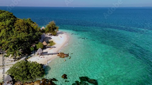 Wallpaper Mural Experience a tranquil beach escape in Thailand with stunning turquoise waters and vibrant green trees. This tropical paradise offers sun-drenched shores, perfect for relaxation and exploration. Torontodigital.ca