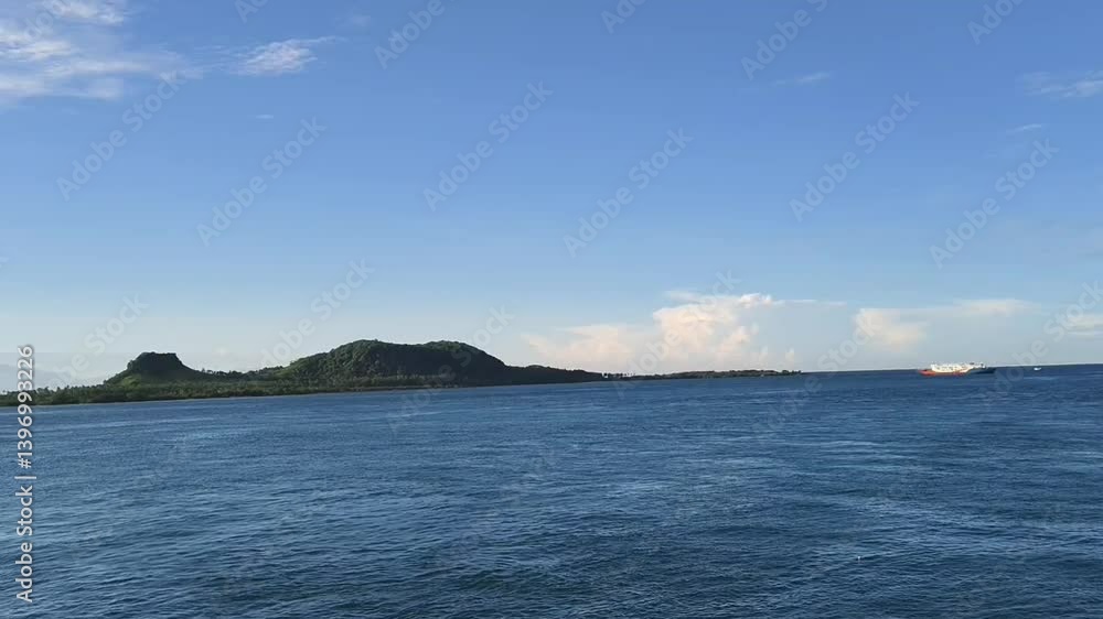 Beautiful view of tropical beach and small islands in Lampung along the Sunda Strait. Panoramic seaside landscape in a highland nature park, with a boat sailing under the sunrise sky Beautiful view of tropical beach and small islands in Lampung along the Sunda Strait. Panoramic seaside landscape in a highland nature park, with a boat sailing under the sunrise sky