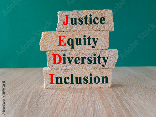 Obraz na płótnie Justice equity diversity inclusion symbol. Concept words JEDI Justice Equity Diversity Inclusion brick blocks. Beautiful green background. Business justice equity diversity inclusion concept. w salonie