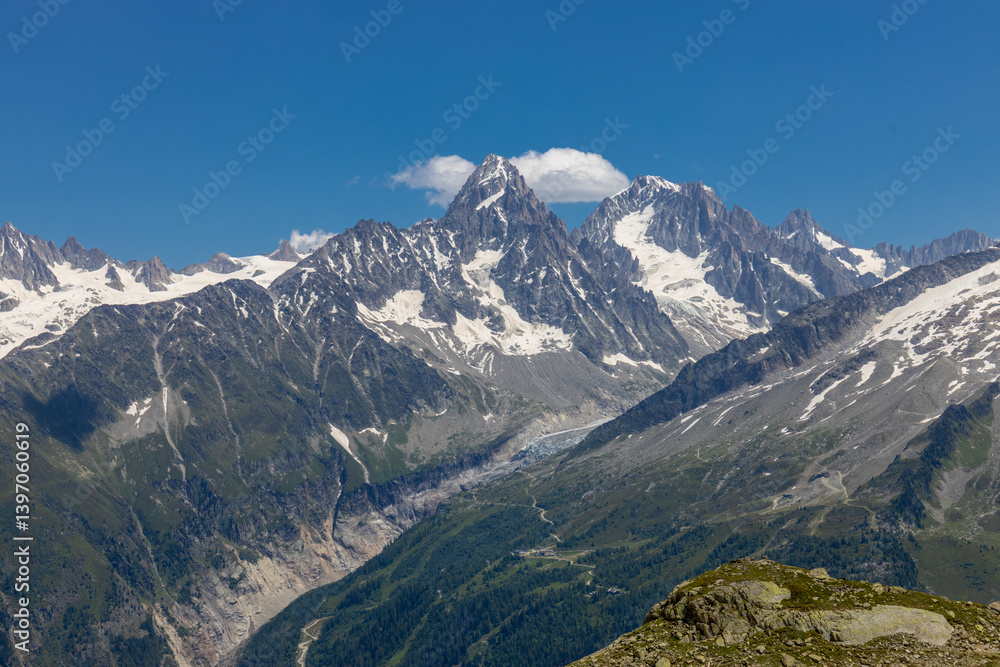 Fototapeta premium Chamonix Montblanc beautiful alpine mountain summits landscape. Alps mountains with snow and glacier above green valley of Chamonix in France. Alps beautiful scenery in summer