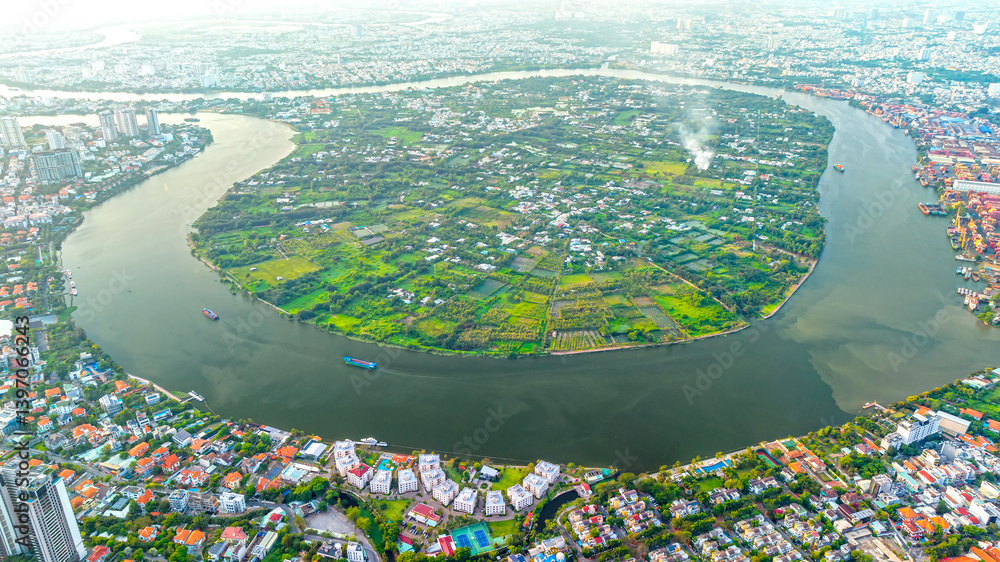 Top view aerial of a Ho Chi Minh City with development buildings, transportation, energy power infrastructure on a winter day. Cityscape on Saigon river in Ho Chi Minh City, Vietnam