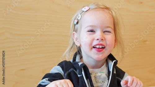 Little child girl having fun and sticking her tongue out