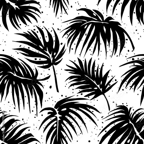 Palm leaves. Pattern of black palm leaves on white background in grunge style. Drawn with brush strokes, splashes, blots.