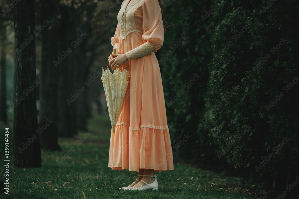 Ταπετσαρία Peach dress touches wet grass as she waits motionless with closed umbrella, her presence ethereal like memory emerging from forest