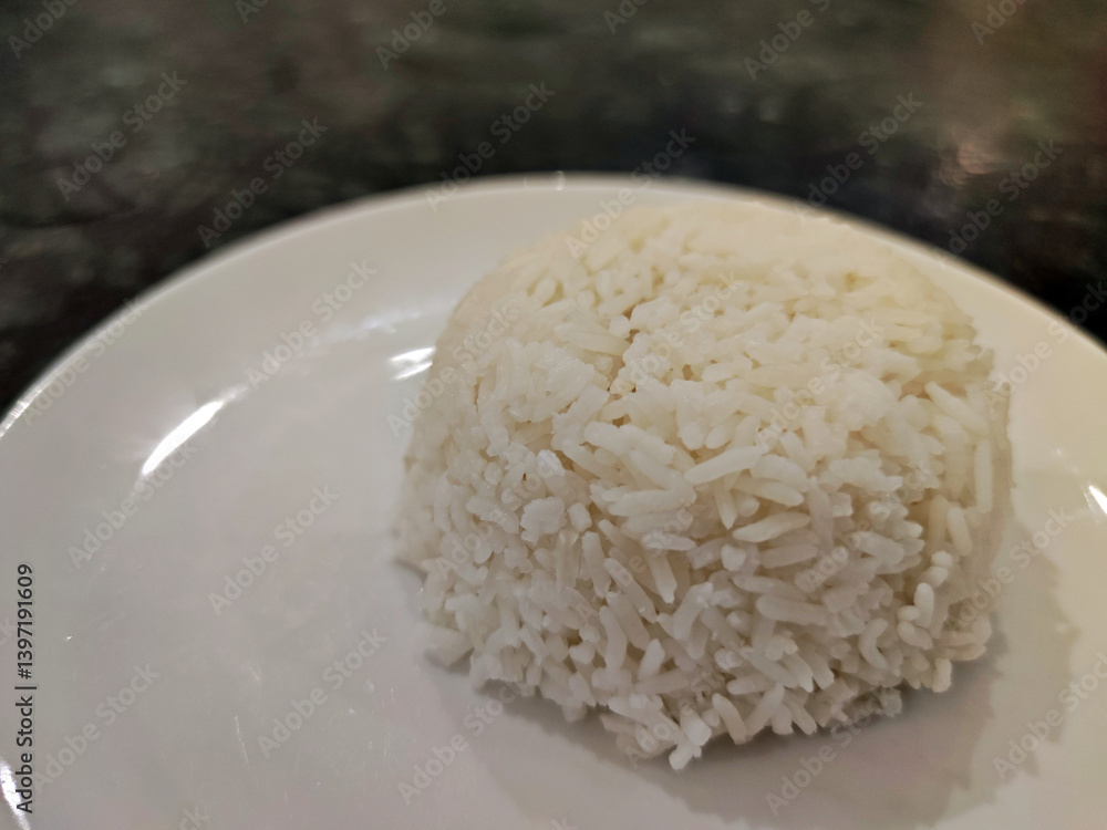 Thai Jasmine rice (White rice), plain rice in white dish on wooden table.