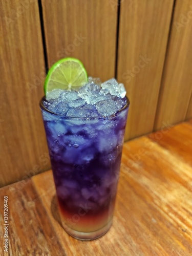 Butterfly pea juice with honey and lemon soda.