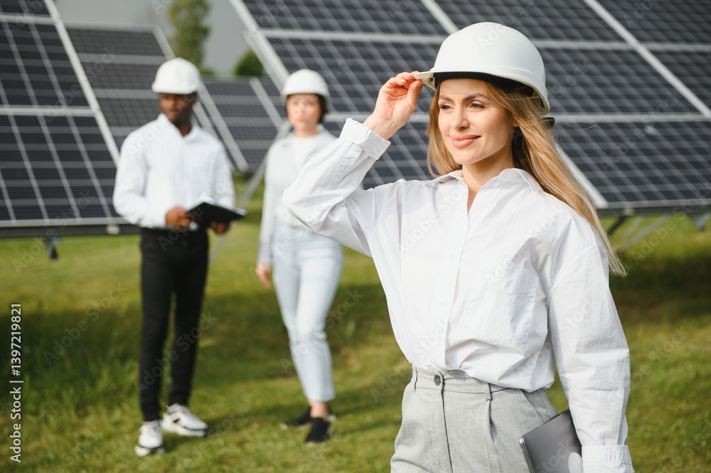 Group of multi ethnic people and safety helmets staring at solar farm. Group of multi ethnic people and safety helmets staring at solar farm.