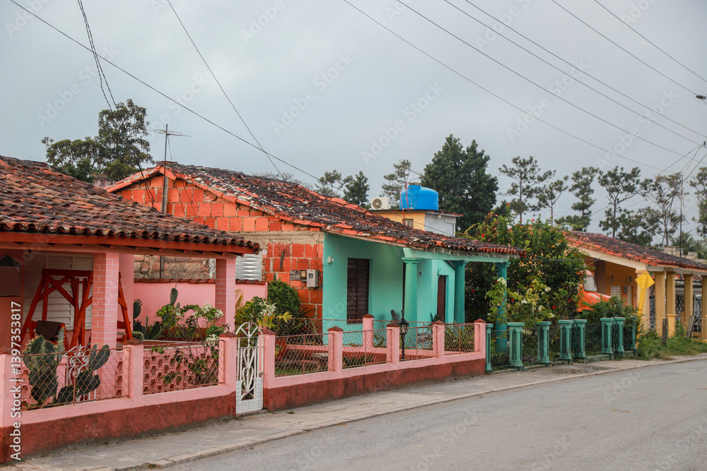 A row of charming, pastel-colored colonial houses in Viñales, Cuba, showcasing traditional architectural elements such as tiled roofs, wooden shutters, and classical columns. cuba A row of charming, pastel-colored colonial houses in Viñales, Cuba, showcasing traditional architectural elements such as tiled roofs, wooden shutters, and classical columns. cuba