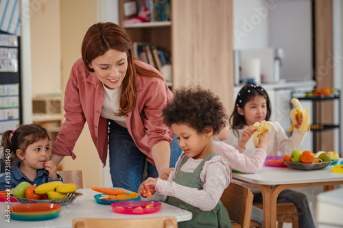 A diverse group of preschool children sits around a table eating healthy snacks while a teacher engages with them, promoting nutrition, inclusion, and social interaction in early education.