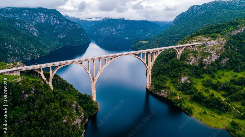 Fototapeta premium Breathtaking View of an Architecturally Designed Bridge Over a Serene Lake Surrounded by Majestic Mountains