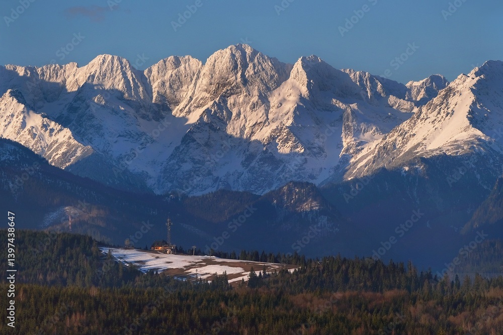 The snow-capped peaks of the High Tatras mountains in sunrise light from viewpoint Pass over Lapszanka (Pass over Łapszanka), Podhale, Poland