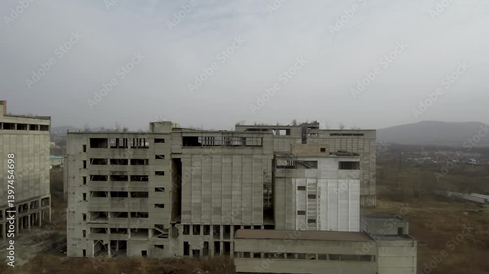 Abandoned Feed Mill Factory. Drone view of a partially constructed Soviet feed production plant, frozen in time since the collapse of the USSR. Abandoned Feed Mill Factory. Drone view of a partially constructed Soviet feed production plant, frozen in time since the collapse of the USSR.