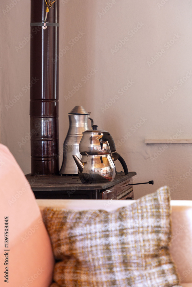 Turkish tea pot warming on top of a wood stove
