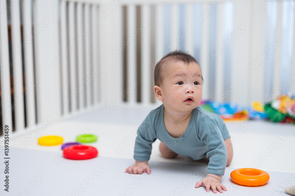 Cute baby crawling on soft play mat