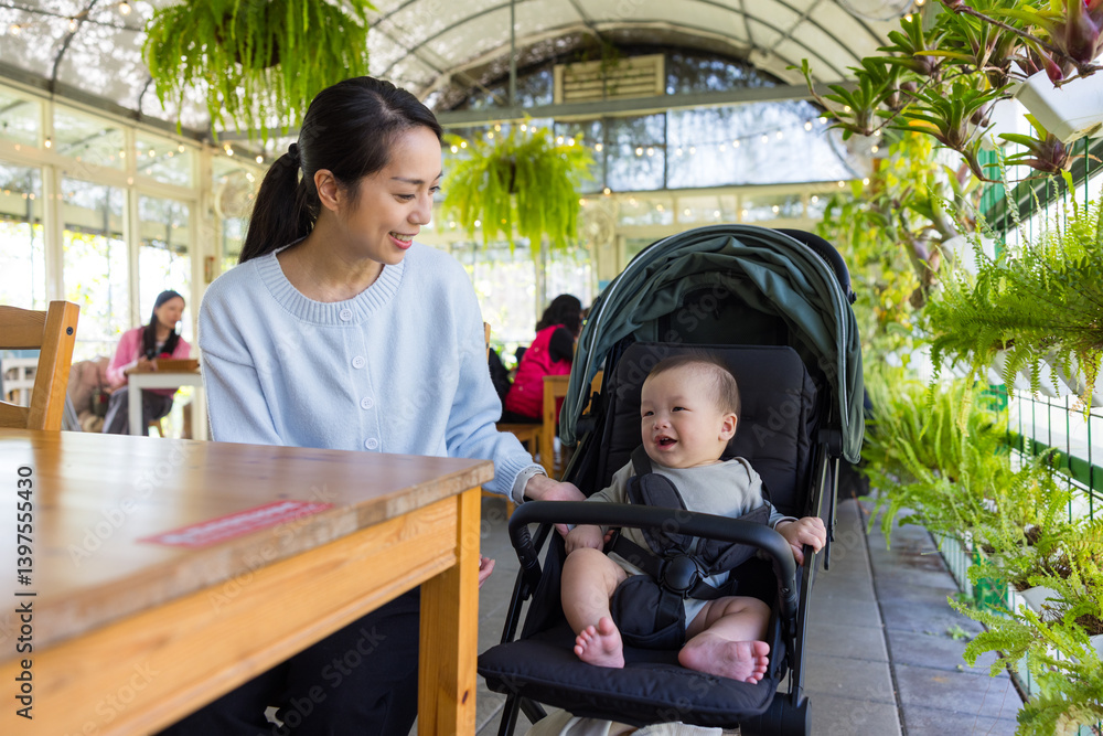 Mother taking care of baby inside coffee shop