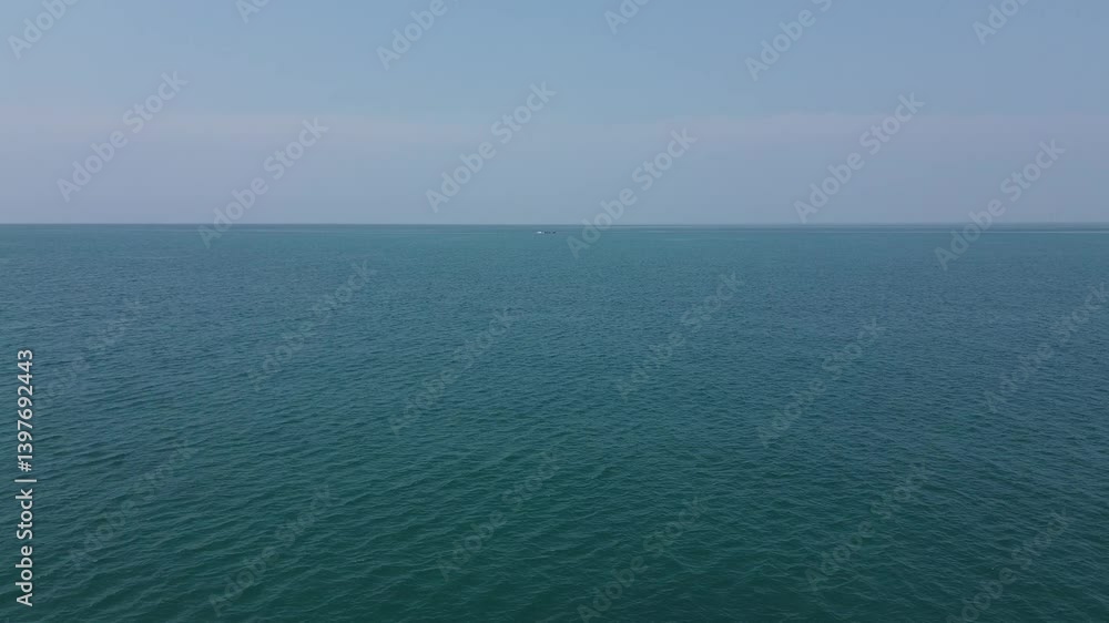 Drone aerial shot of Koh Lanta Island in the Andaman Sea in Thailand with longtail boats in the bay surrounded by beautiful tropical exotic blue water and rocky island with jungle and waves Drone aerial shot of Koh Lanta Island in the Andaman Sea in Thailand with longtail boats in the bay surrounded by beautiful tropical exotic blue water and rocky island with jungle and waves