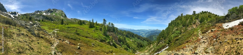 Panoramic mountain view with lush greenery and a clear blue sky Panoramic mountain view with lush greenery and a clear blue sky