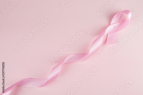 Pink breast cancer awareness ribbon with copy space, pink backgrounnd