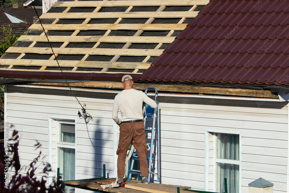 Installation process of metal roofing on a residential building in the afternoon Installation process of metal roofing on a residential building in the afternoon