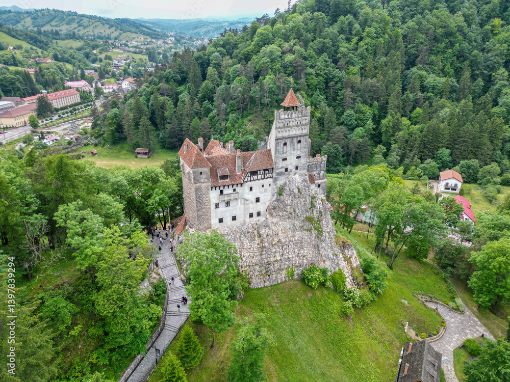 Aerial view of Bran Castle surrounded by lush greenery and scenic mountains, Bran, Brasov, Romania. Aerial view of Bran Castle surrounded by lush greenery and scenic mountains, Bran, Brasov, Romania.